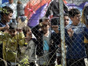 Children look through the fence at the Moira detention facility. (AFP/File)