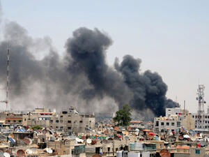 A picture released by the official Syrian news agency SANA shows smoke rising above Damascus after two huge bombs exploded outside the Palace of Justice in Central Damascus on June 28, 2012. (AFP/Sanaa)