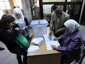 Syrians register to cast their votes at a polling station during parliamentary elections in Damascus on April 13, 2016. (AFP/Joseph Eid)