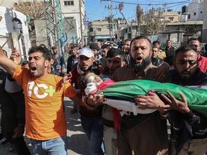 Mourners carry the body of a four-year-old Palestinian boy, who died of Israeli-inflicted wounds, during his funeral in Khan Yunis, Gaza Strip. (AFP)

