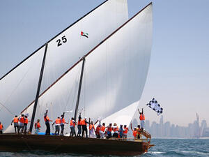 Emirati sailors on board the Zilzal celebrate after being crowned the champions of the Al-Gaffal traditional long-distance dhow sailing race between the island of Sir Bu Nair, near the Iranian coast. (AFP/File)