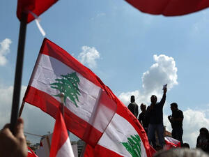 Lebanese wave their national flag in Beirut (AFP/File Photo)