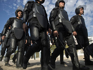 Egyptian riot policemen deploy to disperse supporters of Muslim Brotherhood ousted President Mohamed Morsi outside the police academy in Cairo on Wednesday, when the second hearing in his murder trial was to take place. (AFP/File)