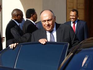 Egyptian Foreign Minister Sameh Shoukry gets in a car after meeting Sudan's President Omar al-Bashir in Khartoum on December 27, 2018. (AFP)