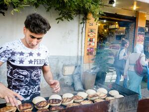 Putting kibbeh on the sidewalk grill outside Bawabat Istanbul (Photo credit: Karim Mostafa)