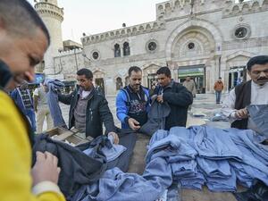 People buying clothes in front of Al-Husseini Mosque on December 9, 2016, in downtown Amman. (Shutterstock) People buying clothes in front of Al-Husseini Mosque on December 9, 2016, in downtown Amman. (Shutterstock)