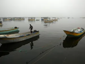 A Palestinian fisherman stands on his boat in Gaza City's seaport during heavy fog on February 26, 2017. (AFP/FILE) 