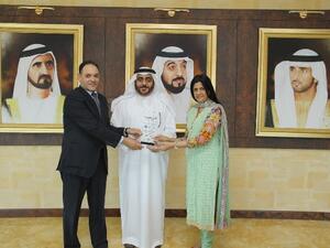Dr. Mansoor Al Awar, Chancellor of HBMSU receiving the award from two of the university deans