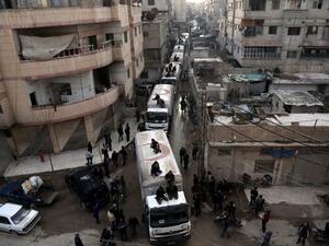 A Red Crescent convoy carrying humanitarian aid arrives in Kafr Batna, in the rebel-held Eastern Ghouta area, outside Damascus on Feb. 23, 2016 during an operation to deliver aid to thousands of besieged Syrians. (AFP/Amer al-Mohibany)