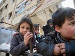 Syrian children in back of truck in besieged Eastern Ghouta (AFP/File Photo)