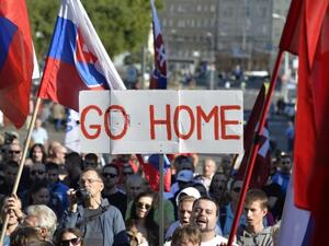Participants hold flags and a banner during an anti-immigration rally organized by an initiative called "Stop Islamisation of Europe" and backed by the far-right "People's Party-Our Slovakia" on September 12, 2015 in Bratislava, Slovakia.  (AFP/Samuel Kubani)