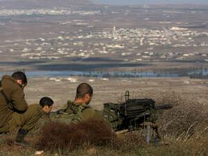 Israeli soldiers stand in an abandoned military outpost overlooking the Israeli-occupied Golan Heights. (AFP/File)