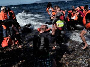 People arrive on the Greek island of Lesbos after making a dangerous voyage from Turkey (AFP/Aris Messinis)