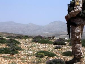 A Hezbollah fighter stands on a hill near the Lebanese-Syrian border of the Qalamun mountains. (AFP/Joseph Eid)