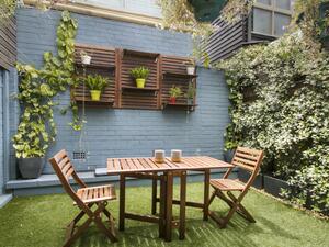 تُعلَّق الأوعية الصغيرة المصنوعة من الفخار والمحتوية على الورود الملوَّنة على الجدار الخارجي تُعلَّق الأوعية الصغيرة المصنوعة من الفخار والمحتوية على الورود الملوَّنة على الجدار الخارجي