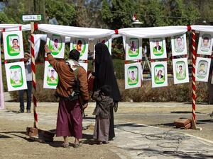 Yemenis look at portraits of Shiite Huthi rebels, reportedly killed in fighting against Saudi-backed Yemeni forces, displayed during an exhibition marking their "Martyrs' Day" on February 27, 2016 in the capital Sanaa. (AFP/Mohammed Huwais)
