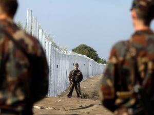 Hungarian soldiers stand guard at the border line between Serbia and Hungary near Roszke village on September 13, 2015. (AFP/Peter Kohalmi)
