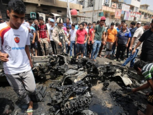 Iraqis inspect damage following a car bomb in Sadr City, Baghdad earlier today. (photo: AFP/Ahmad al Rubaye)