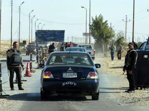 Egyptian police inspect cars at a checkpoint in North Sinai. (AFP/File)
