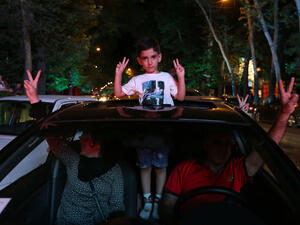 A family celebrates in the streets of Iran's capital Tehran after news of the recent nuclear deal.  (AFP/Atta Kenare)