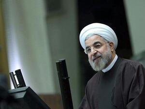 A handout picture released by the Iranian presidency shows the Islamic Republic's President Hassan Rouhani (R) delivering his speech to parliament/ [AFP]