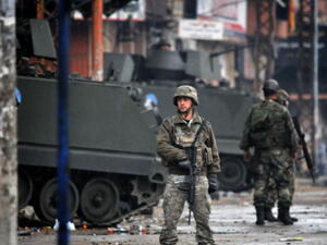 Lebanese army soldiers patrol a street in the northern Lebanese city of Tripoli on December 4, 2013 as the army deployed following clashes between supporters and opponents of Syria's regime. [Ibrahim Chalhoub/AFP]