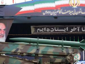  An Iranian surface to surface Zelzal missile is driven past portraits of Iran's late founder of the Islamic republic, Ayatollah Khomeini . (Image credit: Getty)