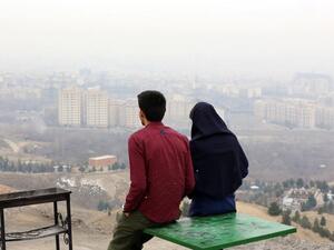 An Iranian couple looks out over Tehran in 2015.  (AFP/File)