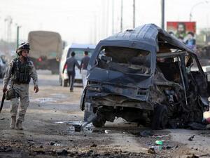 An Iraqi soldier inpects the remains of a vehicle at the scene of a car bomb explosion the previous days in Baghdad's Sadr City district on May 16, 2013 (Ahmad al-Rabaye/ AFP)