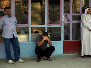 Iraqi men react to the death of family members in the Dora area of south Baghdad (Ahmad al-Rubaye / AFP)