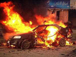 A blaze engulfs a car at the scene of an explosion in the Shiite Muslim Al-Amin district of Baghdad on December 8. [AFP]
