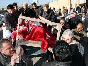 Iraqi men take part in the funeral of four of the five journalists killed in an attack on an Iraqi television station headquarters the day before, in the northern city of Tikrit, during their funeral, on December 24, 2013. [AFP]