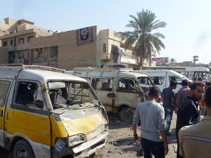 raqis gather following an explosion at a bus station on October 27, 2013, in the the Mashtal district of the capital Baghdad. (Image credit: AFP)