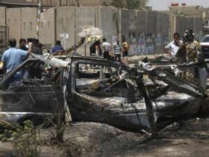 People inspect site of a car bomb attack in Iraq. [presstv]