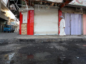 An Iraqi walks on the site of a car bomb that exploded outside a restaurant. (Image credit: AFP)