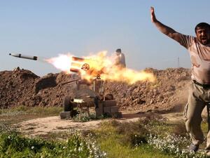 A fighter from the pro-government Popular Mobilization units covers his ears as he sets off a rocket launcher in Taz Khurmatu, outside Kirkuk, as they try to recapture a village from Daesh on February 16, 2016. (AFP/Mohammed Sawaf)