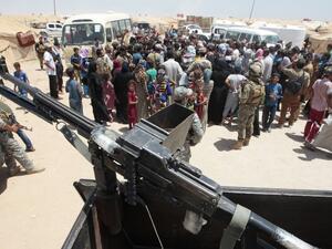 Iraqi civilians who fled the fighting between Iraqi forces and Daesh in Fallujah meet with officials visiting their camp. (AFP/Sabah Arar)