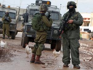 Israeli soldiers are seen during clashes with Palestinian protestors in the village of Qabatiya, near the West Bank town of Jenin on February 22, 2016. (AFP/Jaafar Ashtiyeh)