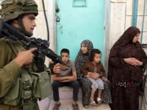 An Israeli soldier patrols a Palestinian town in the West Bank (AFP/File Photo)

