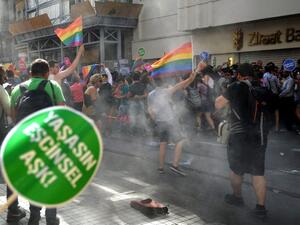 Demonstrators run for cover as Turkish police fire tear gas and rubber bullets at a gay pride march in Istanbul on June 28, 2015.  (AFP/Ozan Kose)