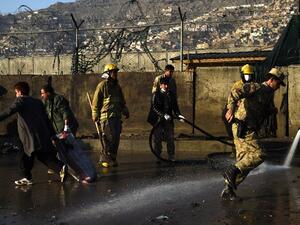 Afghan firefighter wash the site after a Taliban suicide attacker detonated himself at the entrance to a police base in Kabul on February 1, 2016. (AFP/Wakil Kohsar)