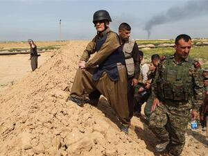 The Iraqi governor of Kirkuk, Najmiddin Karim, stands on a trench alongside Iraqi Kurdish Peshmerga fighters in Kirkuk on March 9, 2015 after the fighters re-took parts of the area from Daesh militants. (AFP/File)
