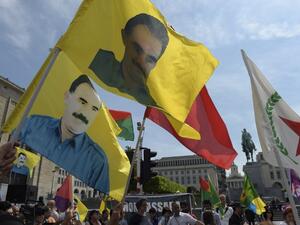 Kurdish protesters wave flags bearing pictures of jailed Kurdish rebel leader Abdullah Ocalan as they attend a demonstration against alleged attacks perpetrated by the Turkish army against Kurds, in Brussels on Aug. 8, 2015. (AFP/John Thys)