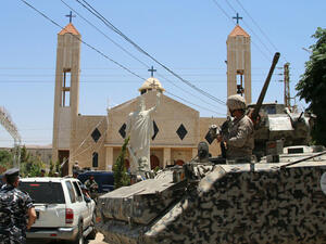 Lebanese soldiers stand guard in front of a church targeted by suicide bombers in al-Qaa. (AFP/Stringer)