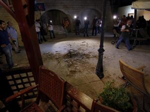 LEBANON, BAABDA : Journalists inspect the damage at a private residence where one of two rockets fired from an unknown location exploded in the early hours of August 2, 2013, just metres from an entrance to the presidential palace in Baabda. AFP PHOTO / ANWAR AMRO