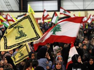 LEBANON, RWEISS : Lebanese women loyal to Hezbollah wave the national flag and Hezbollah flags during a gathering to mark the "Al-Quds (Jerusalem) International Day" from Beirut's southern suburb neighbourhood of Rweiss on August 2, 2013.  AFP PHOTO/ANWAR AMRO