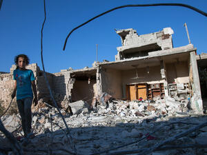 A Syrian girl walks next to the debris of her house, after it was targeted by a missile, in the northwestern Syrian province of Idlib on July 18, 2013. (Source: AFP/DANIEL LEAL-OLIVAS)
