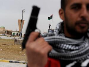 A rebel fighter stands at a roundabout in the center of town in Ajdabiya, Libya on March 15, 2011. (Roberto Schmidt/ AFP) A rebel fighter stands at a roundabout in the center of town in Ajdabiya, Libya on March 15, 2011. (Roberto Schmidt/ AFP)