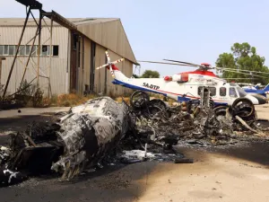 A charred airplane lies on the ground at Tripoli international airport in the Libyan capital on July 14, 2014, following fighting between rival armed groups. (Mahmud Turkia/ AFP)