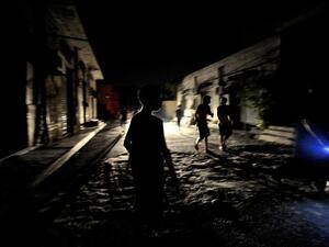 Young boys play outside at nighttime in Tripoli, Libya on August 22, 2011.  (AFP/Filippo Monteforte)